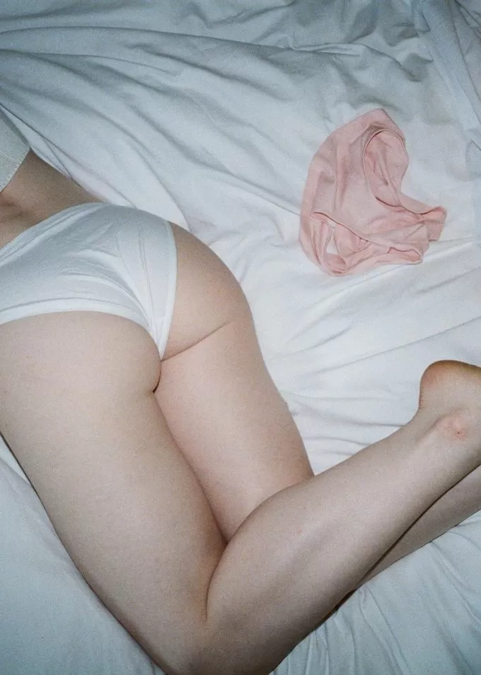 Woman's bottom lying on white sheet