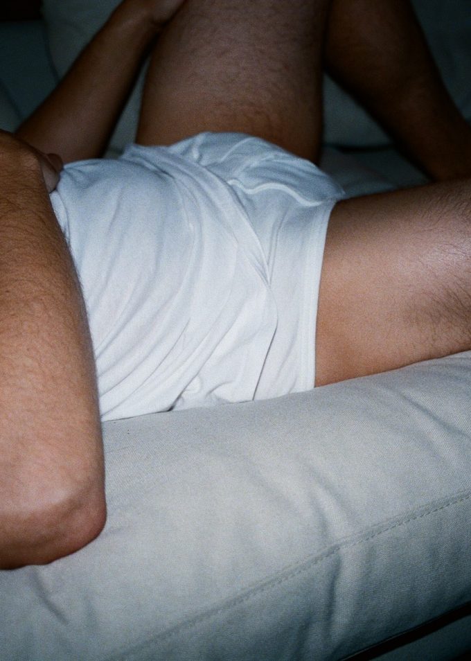 Male torso lying on a sofa
