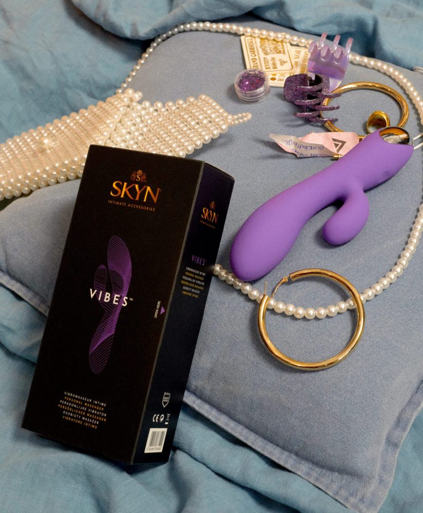 SKYN Vibes sex toy and packaging with jewels around