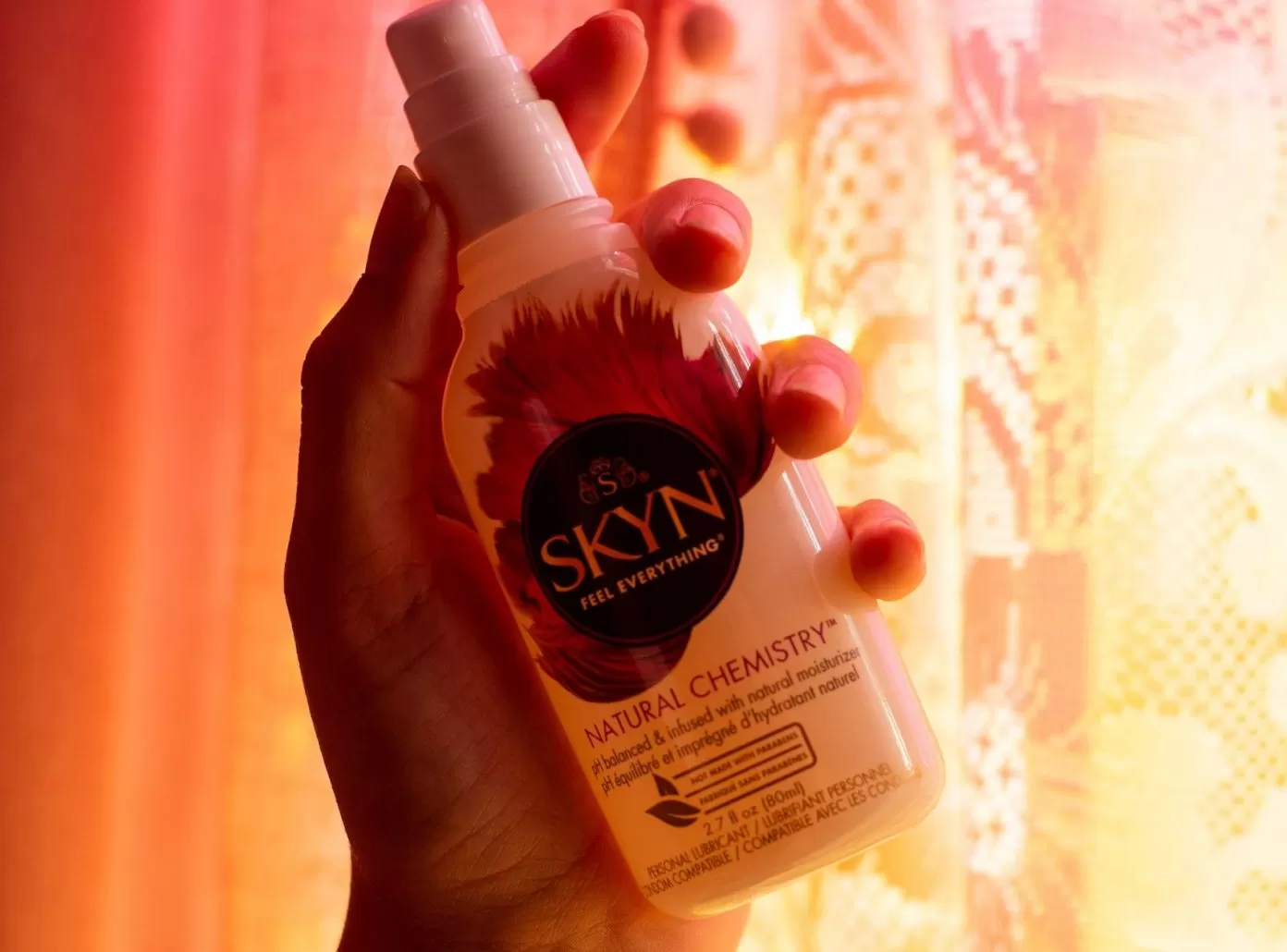 Hand holding SKYN lubricant