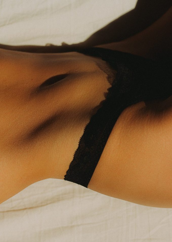 Zoom on woman body with black underwear